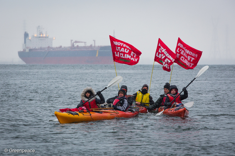 Kayakers join a protest in the Port of Montreal to highlight the risk of an oil spill in the St. Lawrence River. Earlier, Greenpeace Canada climbing activists occupied the pipes used to load tar sands oil onto tankers in the Port of Montreal and hang a banner saying: “Stop Pipelines: Protect Our Water and Climate”. Other activists locked themselves to the front gate. The action follows the federal approval of the Kinder Morgan and Line 3 pipelines and is intended to send a message of pan-Canadian opposition to new pipelines to the December 8-9 First Ministers’ meeting on climate change.